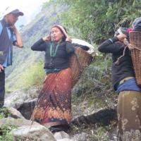 Our porter and local women carrying baskets 